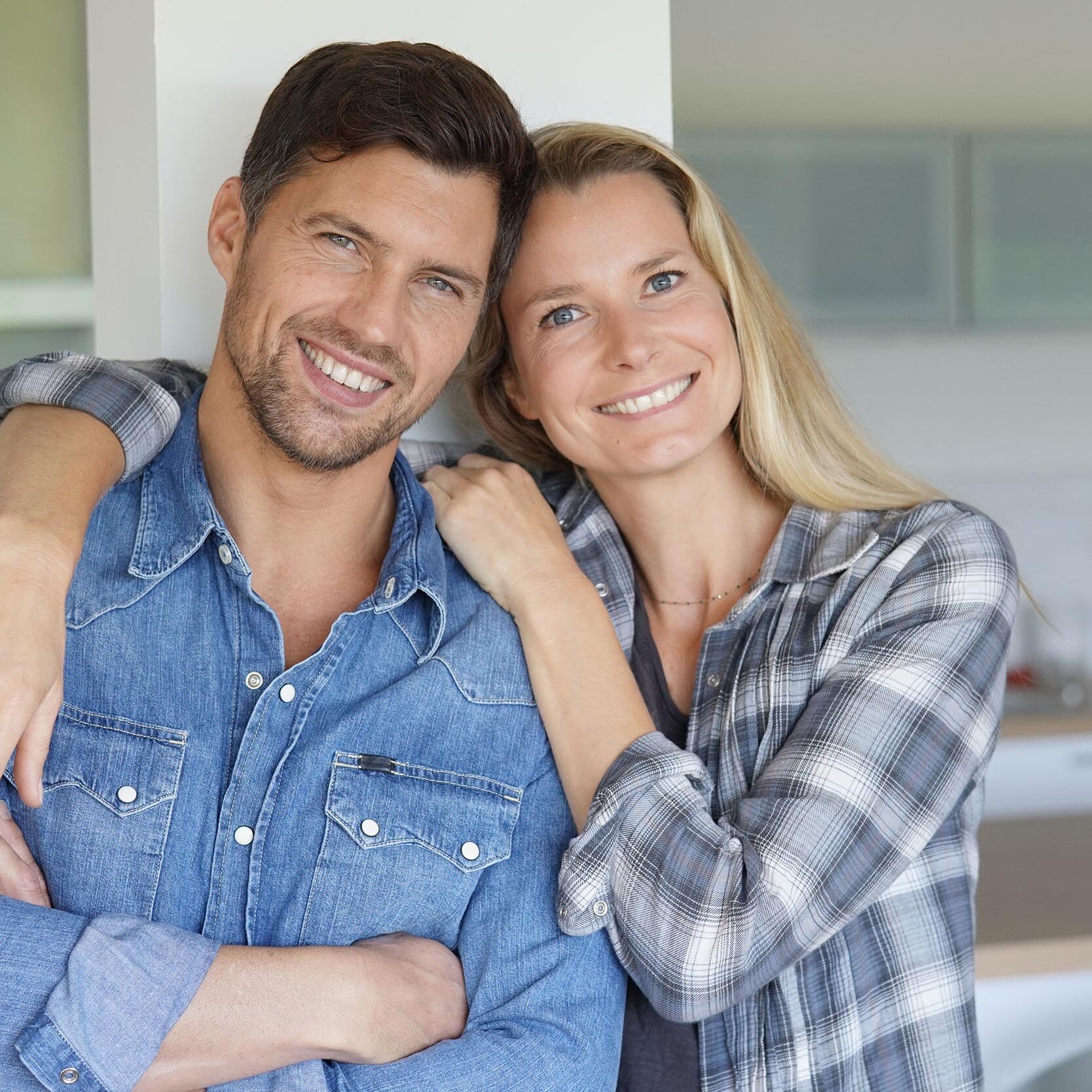 Portrait of cheerful middle-aged couple at home